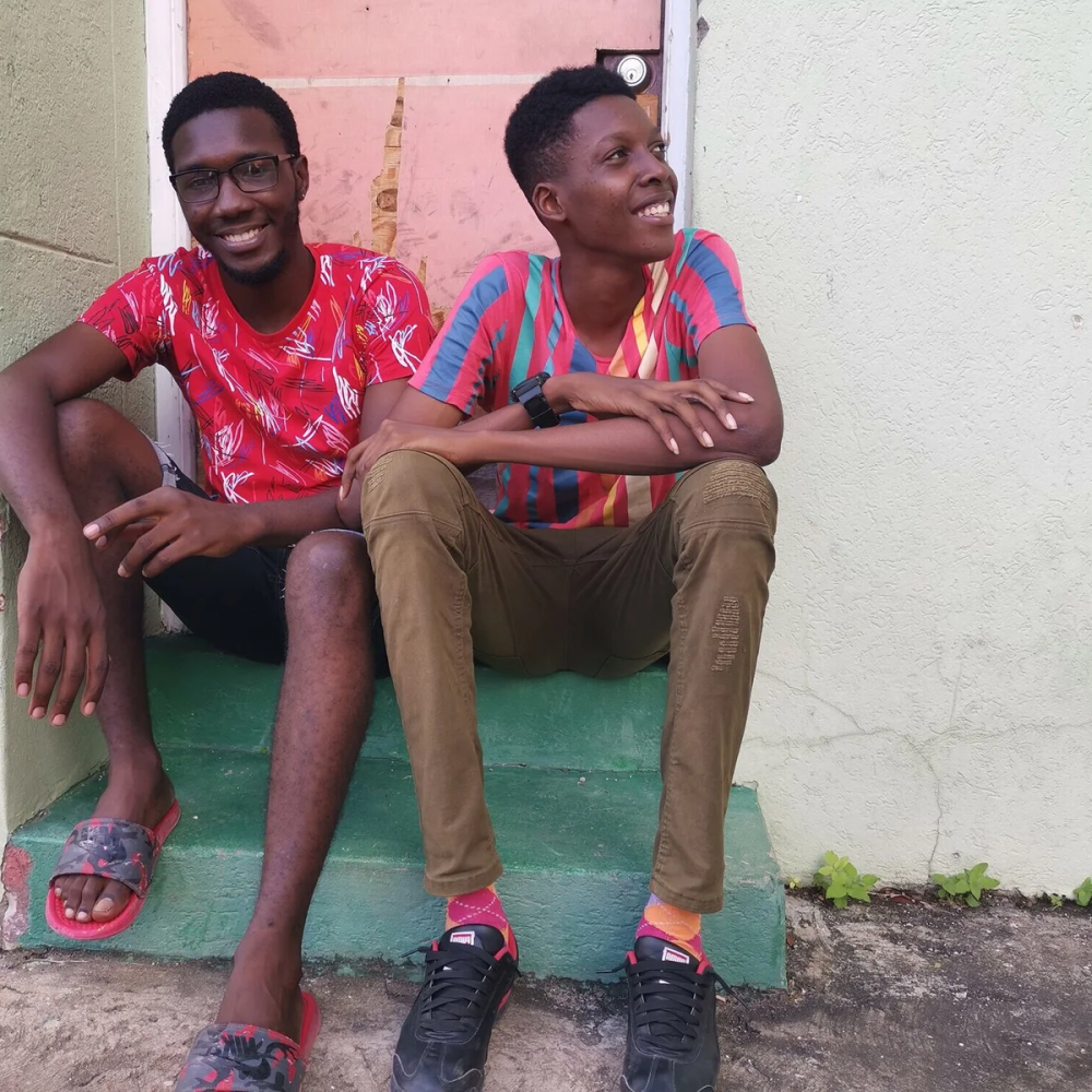 two young men sitting on a stoop